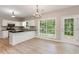 Eat-in kitchen featuring granite counters, white cabinets, and stainless steel appliances at 5705 Cannonero Dr, Alpharetta, GA 30005