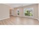 Spacious living room with wood-look floors and large windows offering ample natural light at 5705 Cannonero Dr, Alpharetta, GA 30005