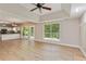 Open-concept living room with hardwood floors, recessed lighting, and a view of the modern kitchen at 5705 Cannonero Dr, Alpharetta, GA 30005