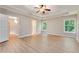 Main bedroom featuring a tray ceiling, fan, and large windows at 5705 Cannonero Dr, Alpharetta, GA 30005
