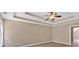 A large main bedroom enhanced by tray ceilings and a ceiling fan at 5705 Cannonero Dr, Alpharetta, GA 30005