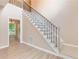 Bright entryway featuring beautiful staircase with wood floors and decorative iron railing at 5705 Cannonero Dr, Alpharetta, GA 30005