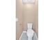 Bright half bathroom with white toilet against neutral wall color and gray tile flooring at 5705 Cannonero Dr, Alpharetta, GA 30005