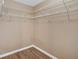Spacious walk-in closet featuring ample shelving and wood-style flooring at 5705 Cannonero Dr, Alpharetta, GA 30005