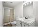 Bathroom with a stand-up shower, white vanity, and ample lighting at 1780 Kinridge Rd, Marietta, GA 30062