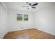 Bedroom featuring wood floors, ceiling fan, large window, and closet at 1780 Kinridge Rd, Marietta, GA 30062