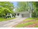 Charming brick home with a carport, landscaped yard, and a long driveway at 1780 Kinridge Rd, Marietta, GA 30062