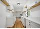 Modern kitchen with white cabinets, quartz countertops, hardwood floors, and open shelves at 1780 Kinridge Rd, Marietta, GA 30062