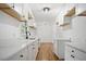 Modern kitchen with white cabinets, quartz countertops, and hardwood floors at 1780 Kinridge Rd, Marietta, GA 30062