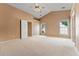 Sunlit bedroom boasts two windows and neutral carpeting, offering a bright and cozy retreat at 2620 Matlin Way, Buford, GA 30519