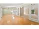 Open floorplan showing dining room with hardwood floors with view into sitting room at 2620 Matlin Way, Buford, GA 30519