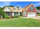 Well-maintained home with lush lawn, traditional architecture, and an inviting curb appeal at 2620 Matlin Way, Buford, GA 30519
