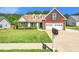 Charming home with a well-manicured front yard, large windows, and a two-car garage at 2620 Matlin Way, Buford, GA 30519