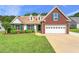 Charming brick and vinyl home featuring a well-manicured lawn and two-car garage at 2620 Matlin Way, Buford, GA 30519