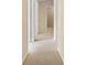 Hallway with plush carpeting and neutral paint leads to other areas of the home at 2620 Matlin Way, Buford, GA 30519