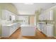 Bright kitchen features an island, stainless steel appliances and white cabinetry at 2620 Matlin Way, Buford, GA 30519