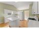 Spacious kitchen boasts a center island, hardwood floors, and white cabinetry at 2620 Matlin Way, Buford, GA 30519
