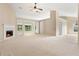 Open-concept living area with neutral walls, fireplace, and large windows overlooking the backyard at 2620 Matlin Way, Buford, GA 30519