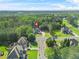 Aerial view of a luxury house in a wooded neighborhood, marked with a pin at 3298 Alcovy Club Ct, Dacula, GA 30019