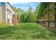 Expansive backyard featuring lush green grass, complemented by a sturdy black fence and mature trees at 3298 Alcovy Club Ct, Dacula, GA 30019
