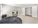 View of finished basement with plush beanbag chair, modern tv, and open doorways at 3298 Alcovy Club Ct, Dacula, GA 30019