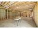Unfinished basement featuring wooden studs and concrete flooring, ready for customization and ample storage at 3298 Alcovy Club Ct, Dacula, GA 30019