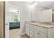 Elegant bathroom with granite countertops, double sinks, and views to an adjacent bedroom at 3298 Alcovy Club Ct, Dacula, GA 30019