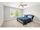 Comfortable bedroom with soft carpet, ceiling fan, and large window for bright natural light at 3298 Alcovy Club Ct, Dacula, GA 30019