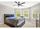 Spacious bedroom featuring a ceiling fan, soft carpet, and plenty of natural light at 3298 Alcovy Club Ct, Dacula, GA 30019