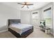 Cozy bedroom featuring a bed with storage drawers, a ceiling fan, and a tv for a relaxed and organized living space at 3298 Alcovy Club Ct, Dacula, GA 30019