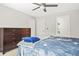Cozy bedroom featuring soft carpet, ceiling fan, and dark wood dresser for ample storage at 3298 Alcovy Club Ct, Dacula, GA 30019