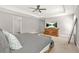 Spacious bedroom with a tray ceiling and a ceiling fan, complemented by a stylish wooden dresser with a television at 3298 Alcovy Club Ct, Dacula, GA 30019