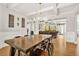 Open-concept dining room featuring a coffered ceiling and an elegant chandelier at 3298 Alcovy Club Ct, Dacula, GA 30019