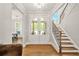 Elegant foyer with hardwood floors, staircase, and a view into the adjacent dining room at 3298 Alcovy Club Ct, Dacula, GA 30019