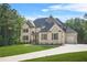 Beautiful brick home with a well-kept lawn, attached garage, and a driveway at 3298 Alcovy Club Ct, Dacula, GA 30019