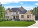 Elegant two-story home with brick facade, a well-manicured lawn, and a welcoming entrance at 3298 Alcovy Club Ct, Dacula, GA 30019