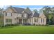 Stunning brick home featuring a manicured lawn and classic architectural details at 3298 Alcovy Club Ct, Dacula, GA 30019