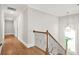 Hallway with hardwood floors, decorative lighting, and views to the outdoors at 3298 Alcovy Club Ct, Dacula, GA 30019