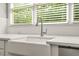 Close-up of a kitchen sink with white countertops and stainless steel faucet at 3298 Alcovy Club Ct, Dacula, GA 30019
