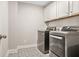 Convenient laundry room featuring modern washer and dryer and stylish patterned flooring at 3298 Alcovy Club Ct, Dacula, GA 30019