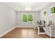Bright home office with hardwood floors, natural light, and a stylish desk at 3298 Alcovy Club Ct, Dacula, GA 30019