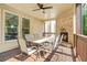 Relaxing outdoor patio featuring a stone fireplace, ceiling fan, and shaded dining area at 3298 Alcovy Club Ct, Dacula, GA 30019
