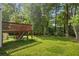 A spacious backyard showing a grassy area, and a deck on a traditional home at 4331 E Kings Point Circle, Dunwoody, GA 30338
