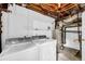 Basement laundry room with washer, dryer, water heater, and plenty of space for storage at 4331 E Kings Point Circle, Dunwoody, GA 30338