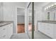 Bright bathroom with granite countertops, double vanity, dual sinks, mirror, and tile flooring at 4331 E Kings Point Circle, Dunwoody, GA 30338