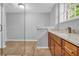 Modern bathroom featuring granite countertops, wood cabinets, and a frameless glass shower door at 4331 E Kings Point Circle, Dunwoody, GA 30338