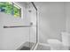 Bathroom featuring a glass-enclosed shower, window, and a white commode at 4331 E Kings Point Circle, Dunwoody, GA 30338