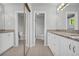 Bright bathroom features double sinks, granite countertops, white cabinetry, and ample mirror space at 4331 E Kings Point Circle, Dunwoody, GA 30338