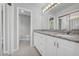 Well-lit bathroom features granite countertops, dual sinks, white cabinets, and an accent mirror at 4331 E Kings Point Circle, Dunwoody, GA 30338