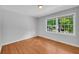 Inviting bedroom features hardwood floors and a large window overlooking a lush yard at 4331 E Kings Point Circle, Dunwoody, GA 30338